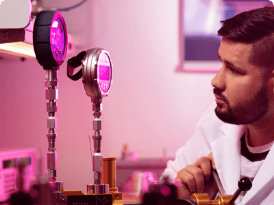 Technician working in lab calibrating pressure gauges