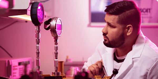 Technician working in lab calibrating pressure gauges